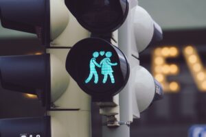 closeup shot of a traffic light showing a man and a woman holding hands