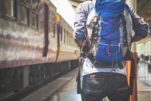 traveler man waits train on railway platform